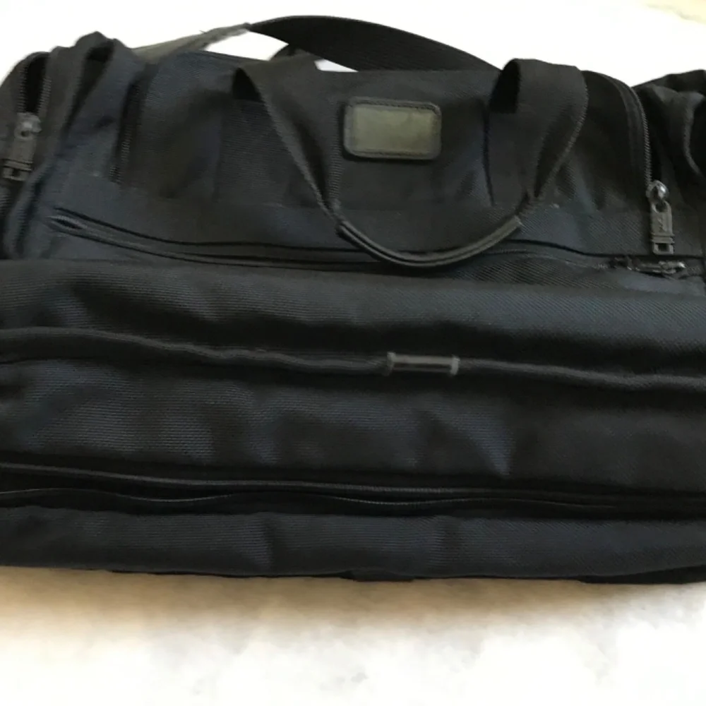 Tumi Black expandable laptop bag. clean interior. Work, travel, Classic